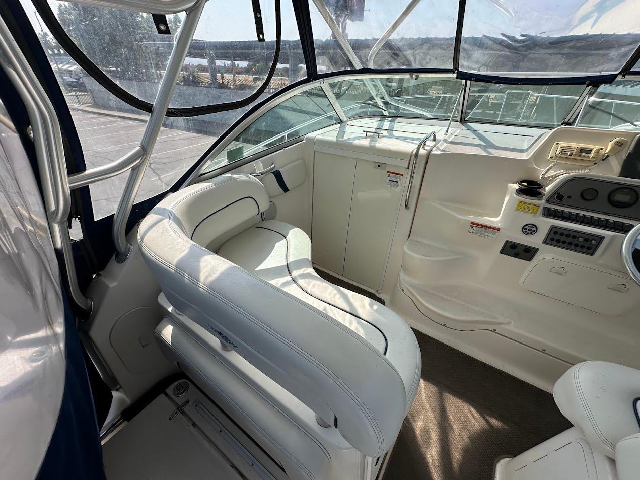 2006 Wellcraft 290 Coastal boat interior with white seating and control panel.