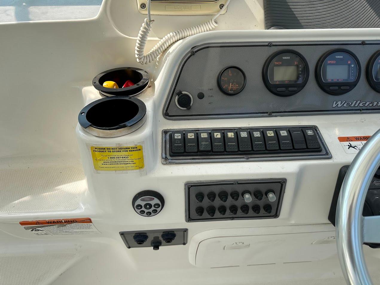 Control panel of a 2006 Wellcraft 290 Coastal boat with gauges and switches.