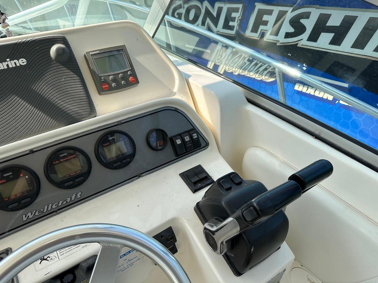 Control panel of 2006 Wellcraft 290 Coastal boat with gauges and throttle.