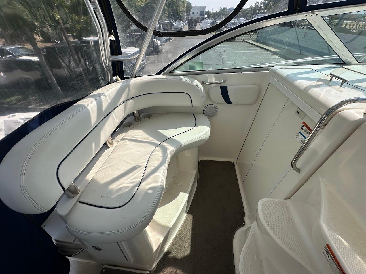 2006 Wellcraft 290 Coastal boat interior with white seating and clear canopy.