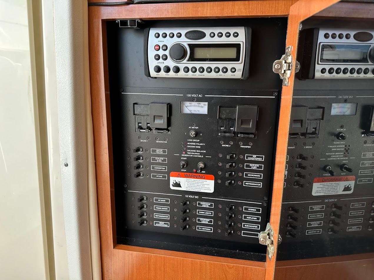 Electrical control panel inside 2006 Wellcraft 290 Coastal boat, featuring switches and a radio unit.