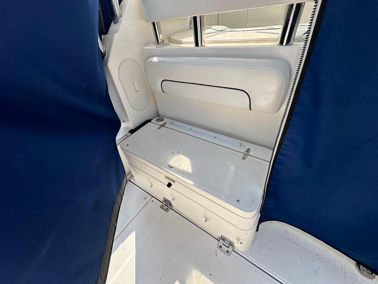 2006 Wellcraft 290 Coastal interior with blue and white seating and storage.