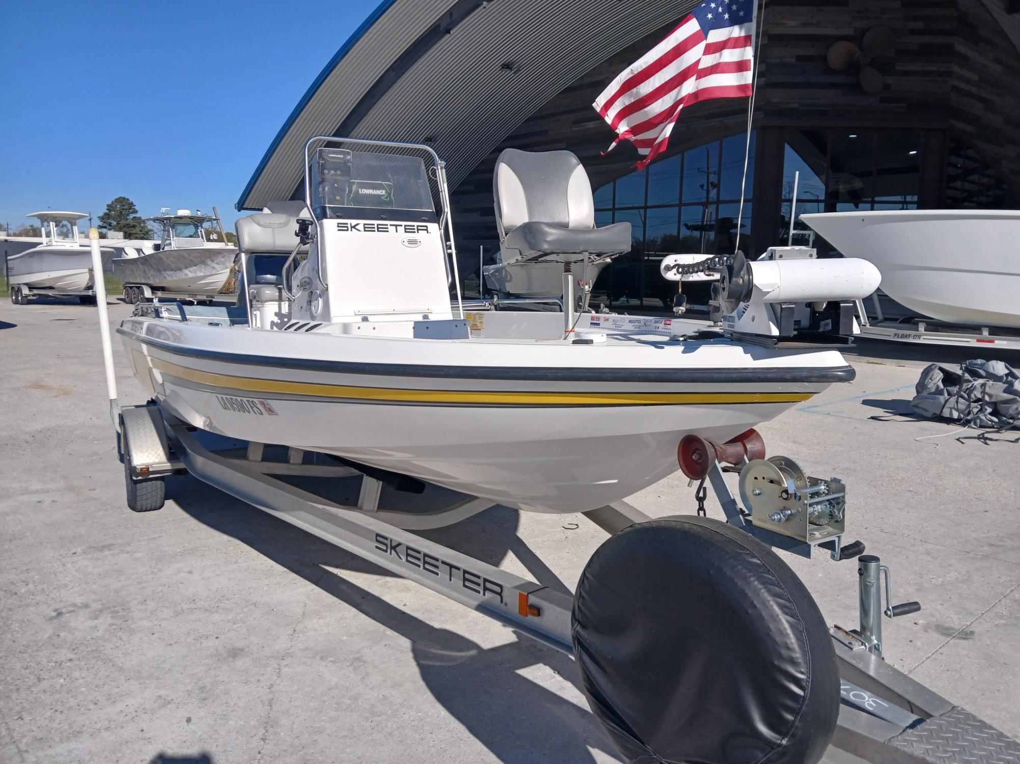 2008 Skeeter 20 ZX boat on trailer with American flag, parked outdoors.