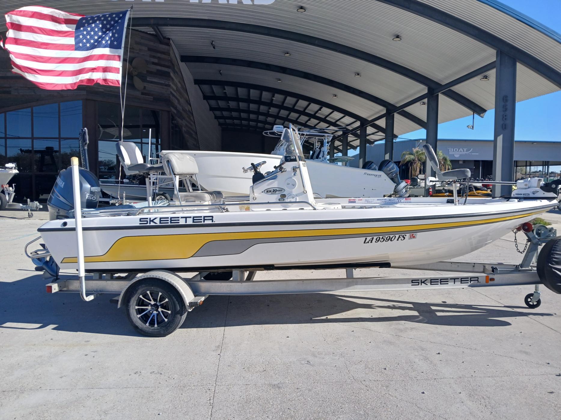 2008 Skeeter 20 ZX boat on trailer, American flag, outdoor showroom background.