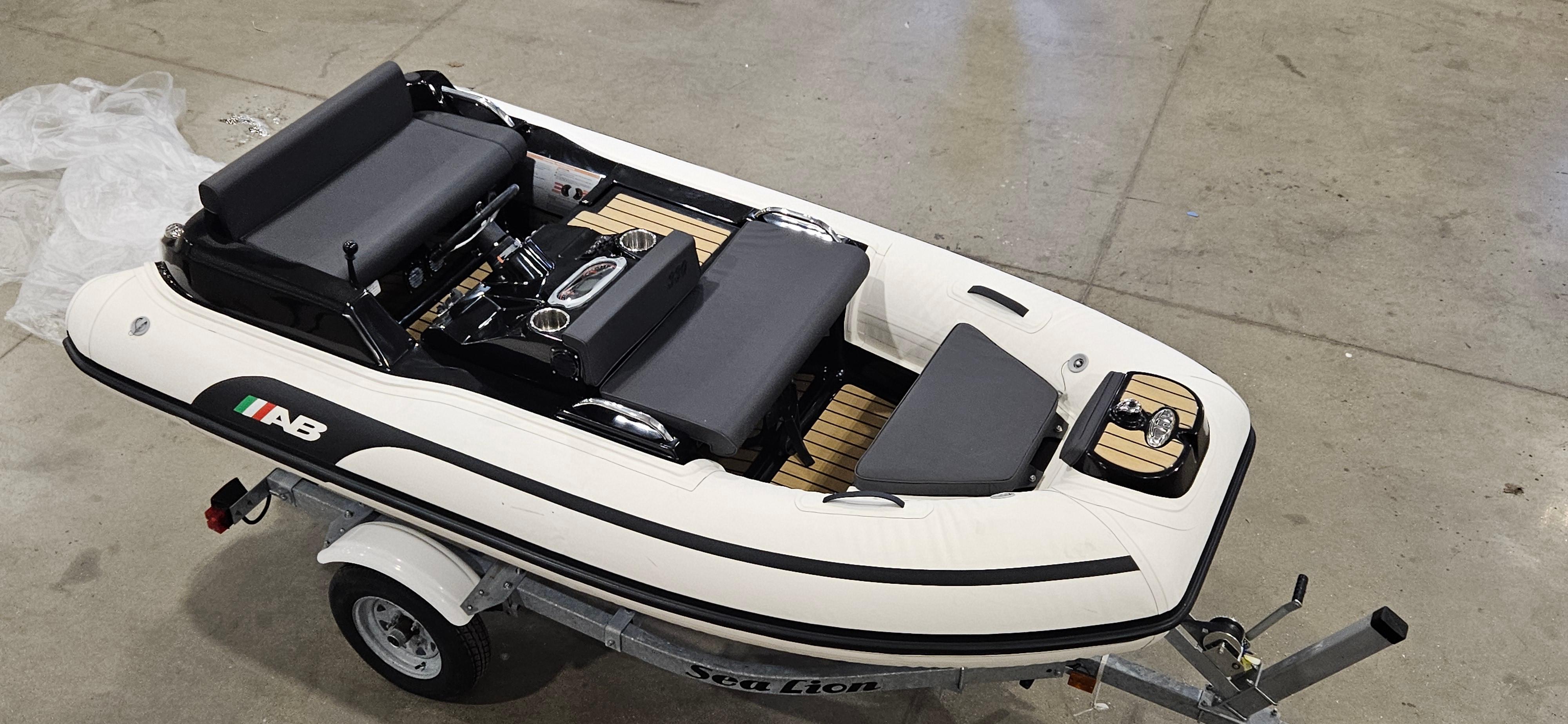 2025 AB Inflatables 330 Jet Boat on trailer in a garage setting.
