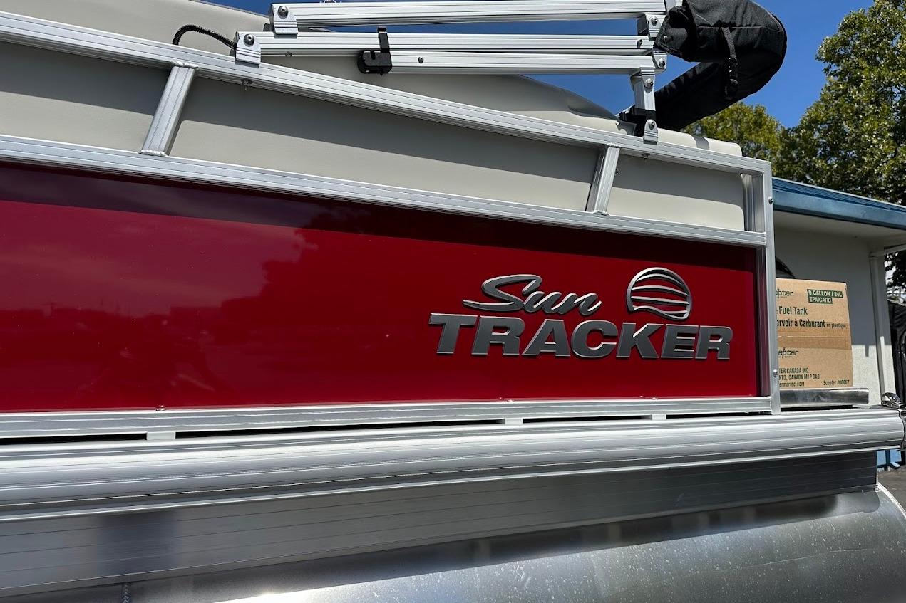 2026 Sun Tracker Bass Buggy 16 XL Select pontoon boat with red and silver detailing.