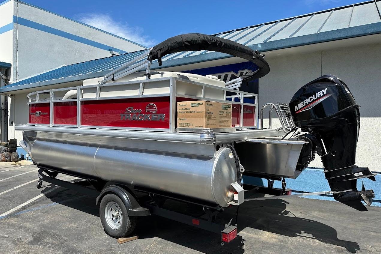2026 Sun Tracker Bass Buggy 16 XL Select pontoon boat with Mercury outboard motor.