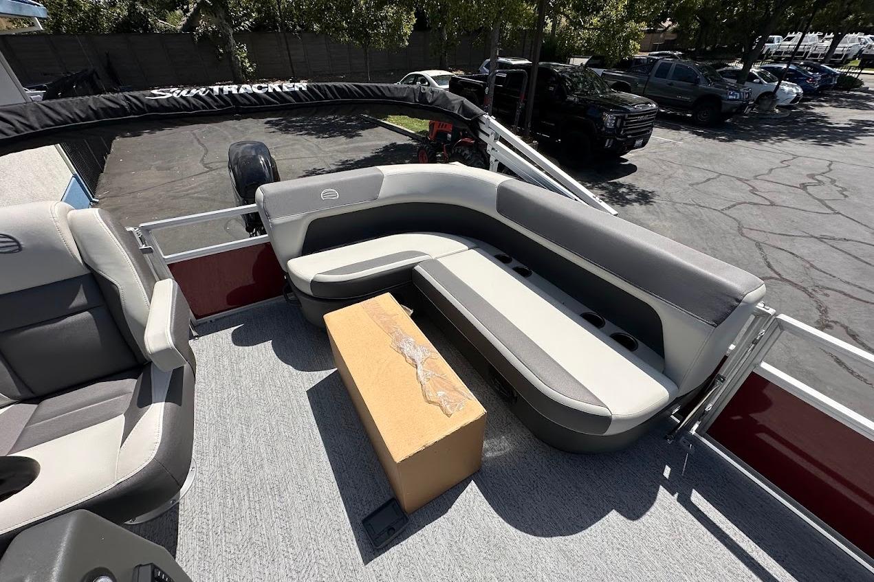 2026 Sun Tracker Bass Buggy 16 XL Select pontoon boat interior with seating and storage.