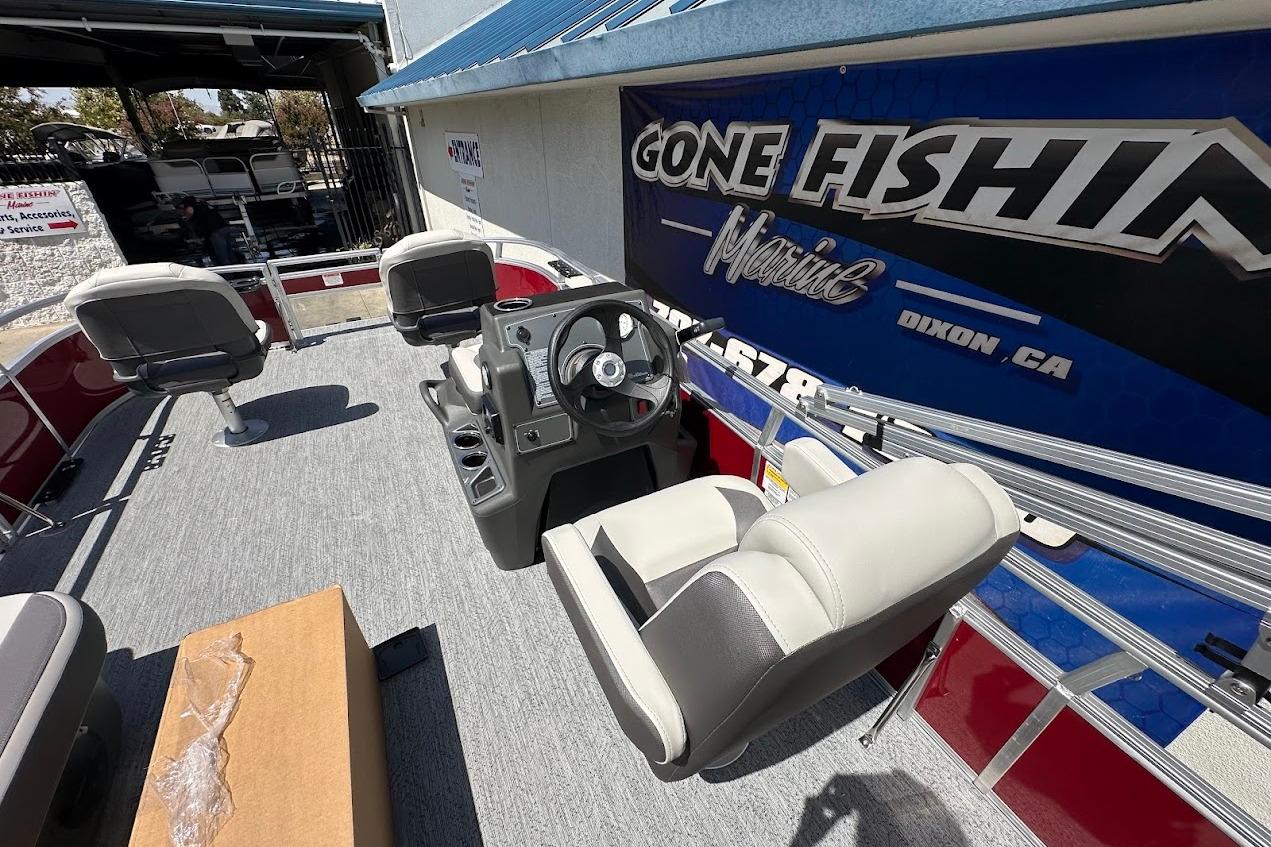2026 Sun Tracker Bass Buggy 16 XL Select pontoon boat interior with seating and steering console.