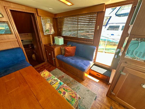 Interior of 1994 Grand Banks 42 Classic yacht with cozy seating and wooden accents.