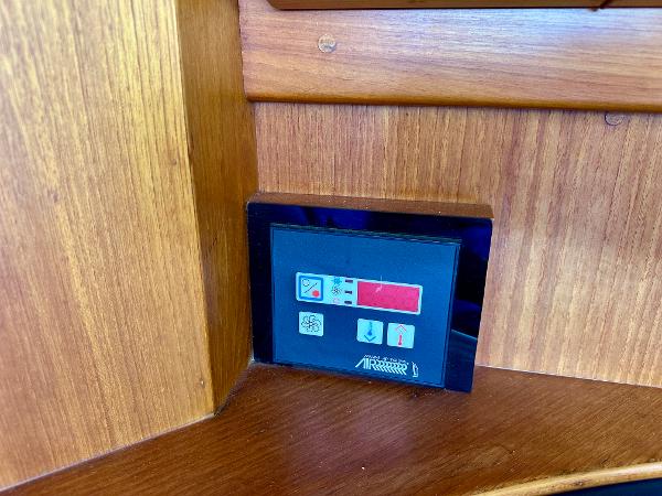 Control panel on 1994 Grand Banks 42 Classic yacht, set in wooden interior.