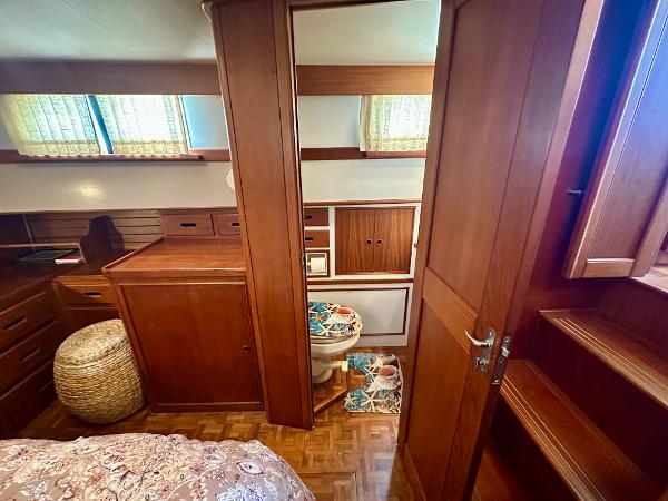 Interior of 1994 Grand Banks 42 Classic yacht with wooden cabinetry and cozy decor.