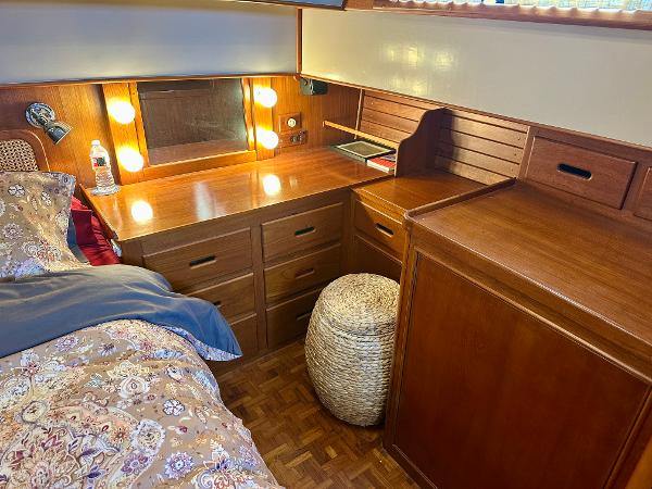 Cozy cabin interior of 1994 Grand Banks 42 Classic with wooden desk and bed.