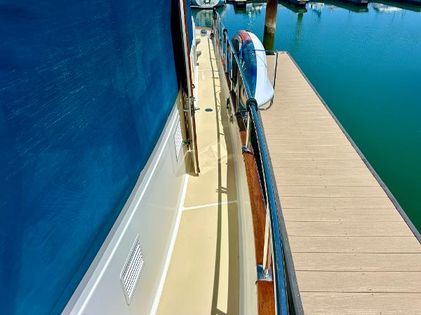 Side deck of 1994 Grand Banks 42 Classic yacht docked at marina.