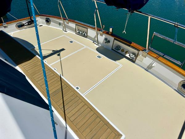Deck of 1994 Grand Banks 42 Classic yacht with wooden accents and railing.