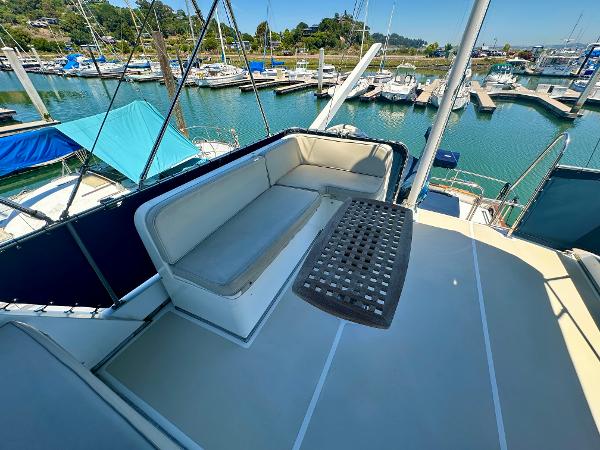 Flybridge seating on 1994 Grand Banks 42 Classic yacht, docked in a marina.