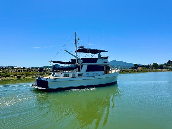 1994 Grand Banks 42 Classic yacht cruising on a sunny day in calm waters.