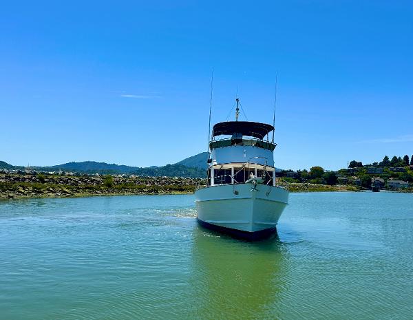 1994 Grand Banks 42 Classic yacht on calm water under clear blue sky.