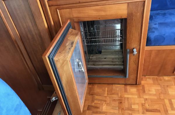 Open wooden cabinet with stainless steel interior on a 1994 Grand Banks 42 Classic yacht.