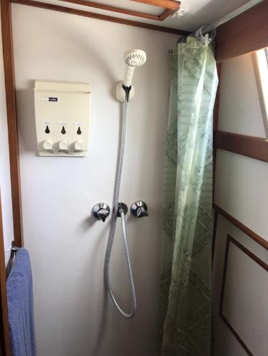Shower area in 1994 Grand Banks 42 Classic yacht with dispenser and curtain.