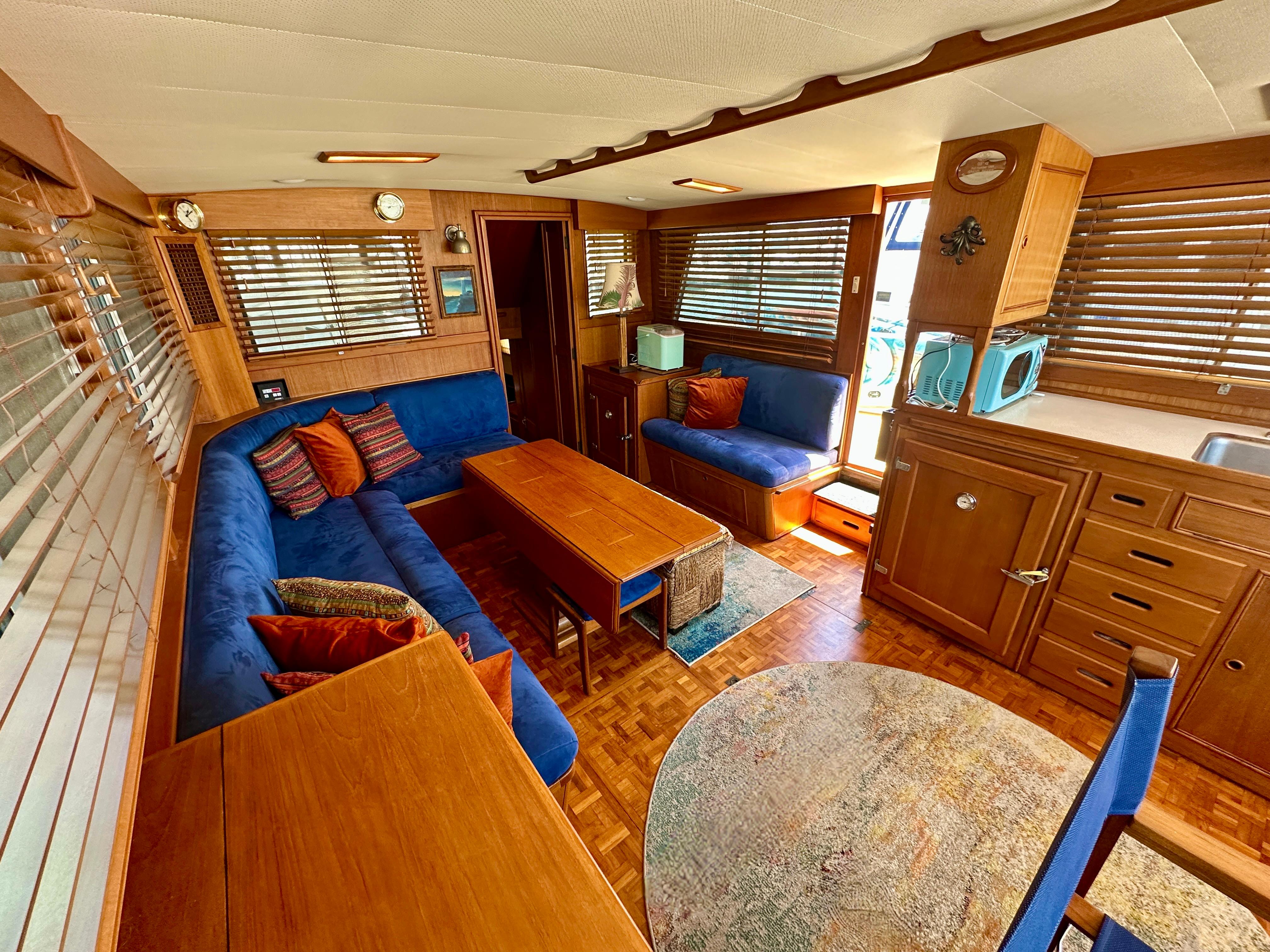 Luxurious 1994 Grand Banks 42 Classic yacht interior with blue seating, wooden accents, and nautical decor.
