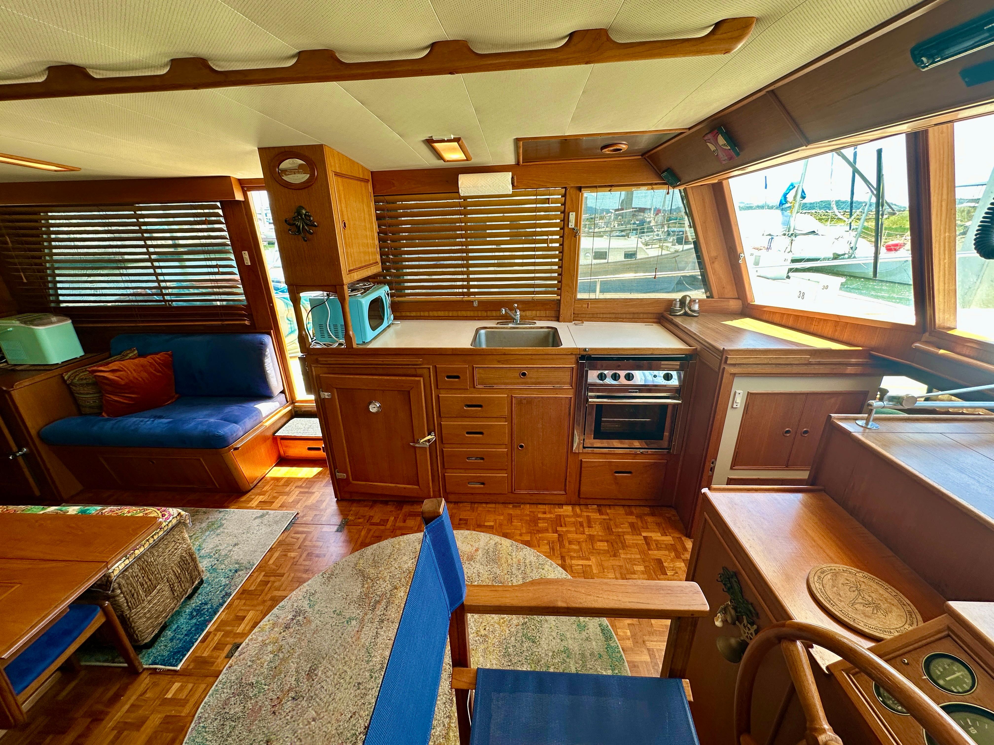 Interior of a 1994 Grand Banks 42 Classic yacht with wooden cabinetry and nautical decor.