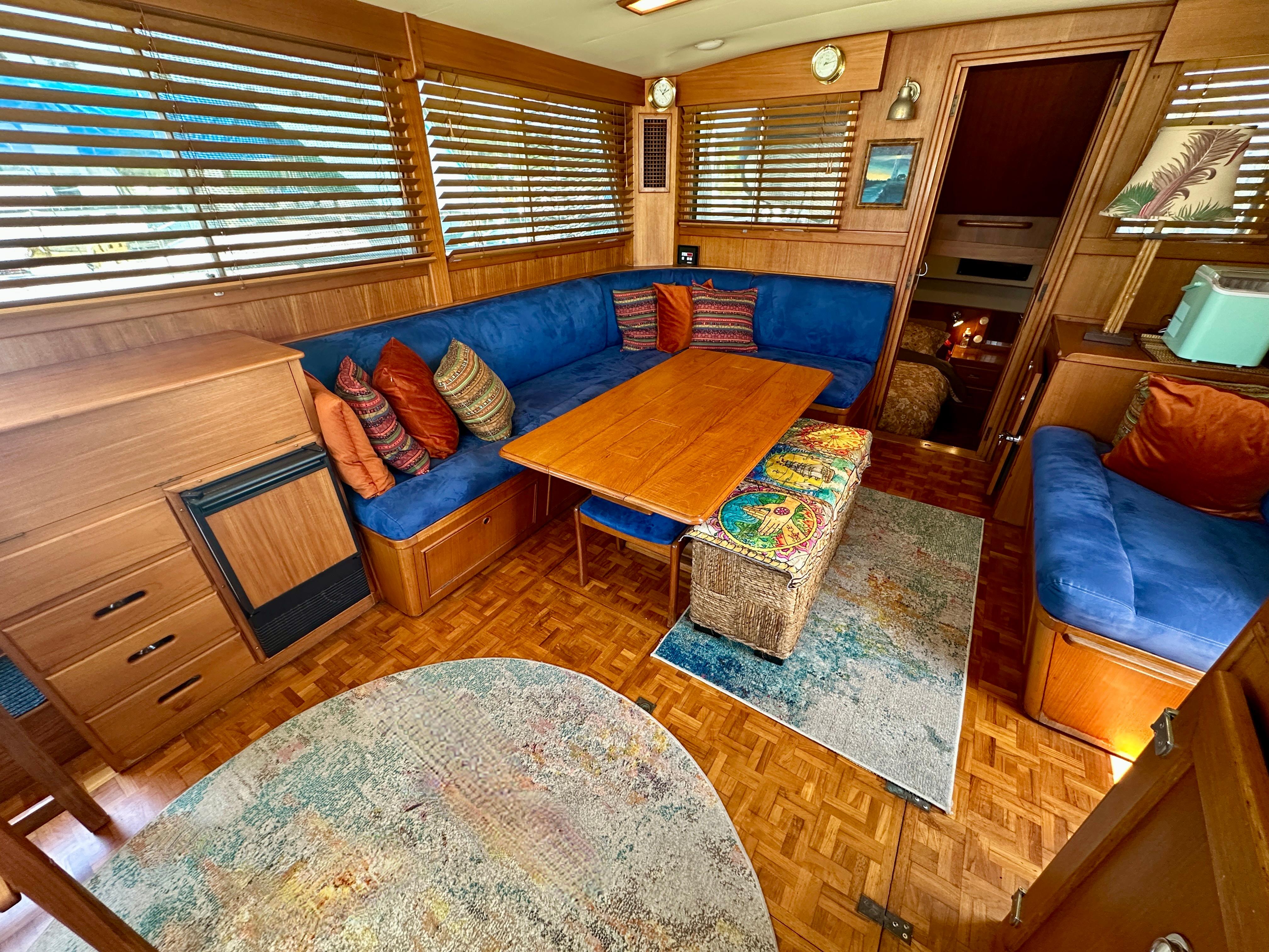 Interior of 1994 Grand Banks 42 Classic yacht with cozy seating and wooden accents.