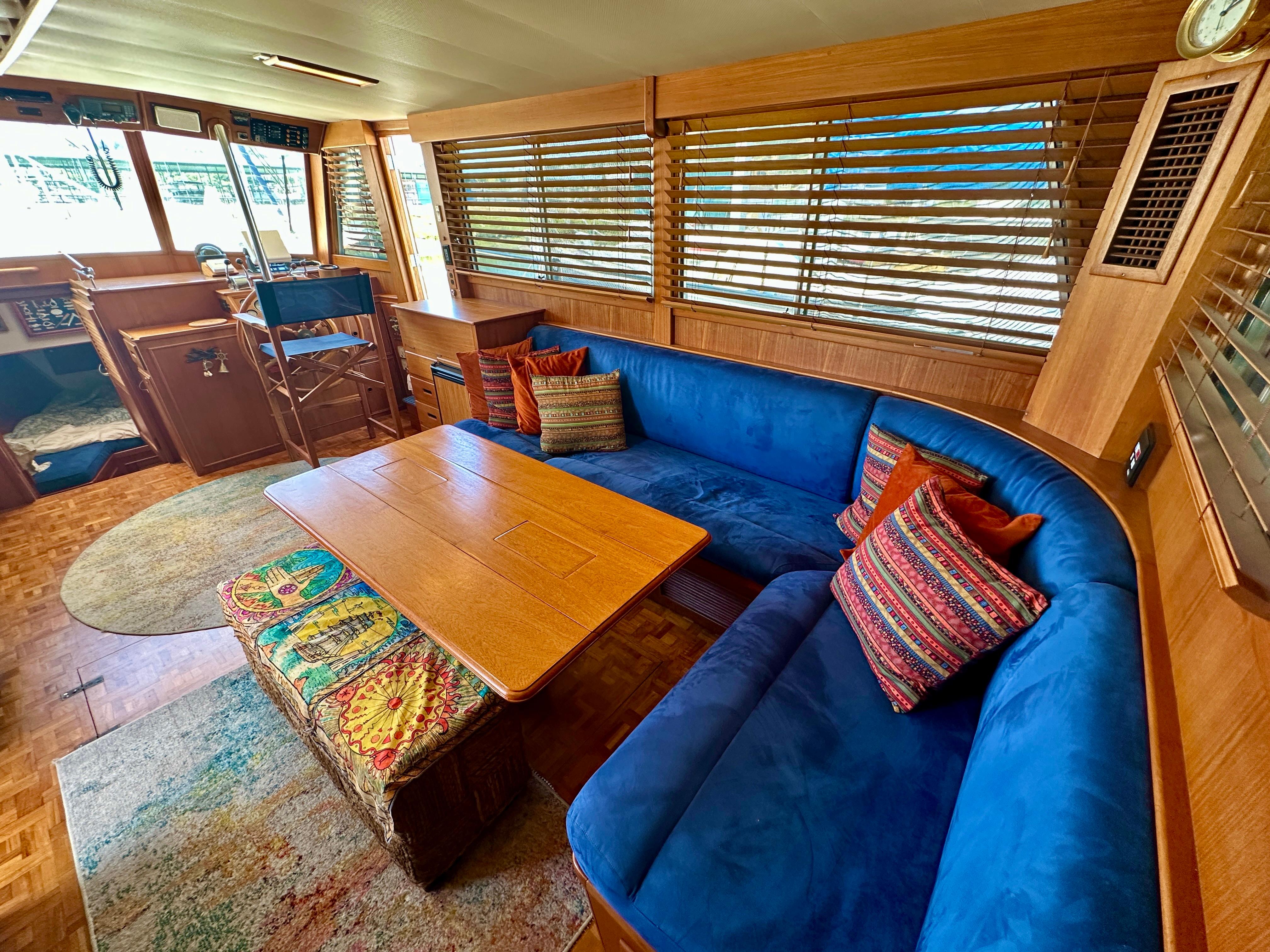 Luxurious interior of 1994 Grand Banks 42 Classic yacht with blue seating and wooden accents.