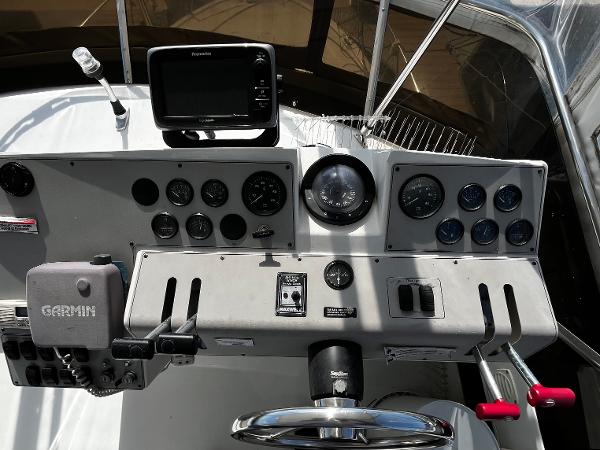1996 Carver 325 Aft Cabin helm with Garmin and Raymarine navigation systems.