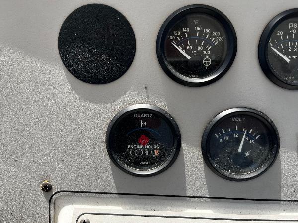 Instrument panel of a 1996 Carver 325 Aft Cabin boat showing gauges and engine hours.