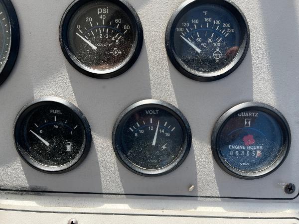 1996 Carver 325 Aft Cabin dashboard with fuel, volt, PSI, temperature, and engine hour gauges.