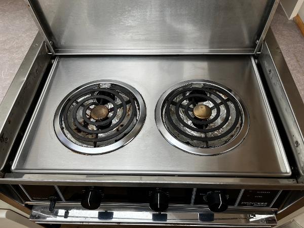 Stainless steel two-burner stove in 1996 Carver 325 Aft Cabin yacht kitchen.