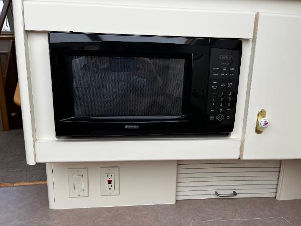 Built-in microwave in 1996 Carver 325 Aft Cabin yacht kitchen area.