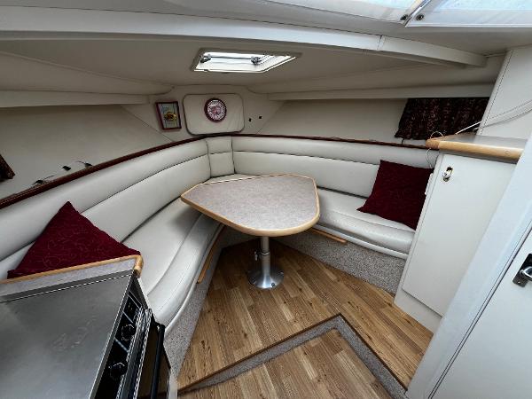 1996 Carver 325 Aft Cabin interior with cozy seating and dining area.