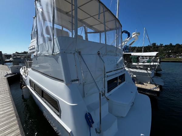 1996 Carver 325 Aft Cabin yacht docked at marina under clear blue sky.