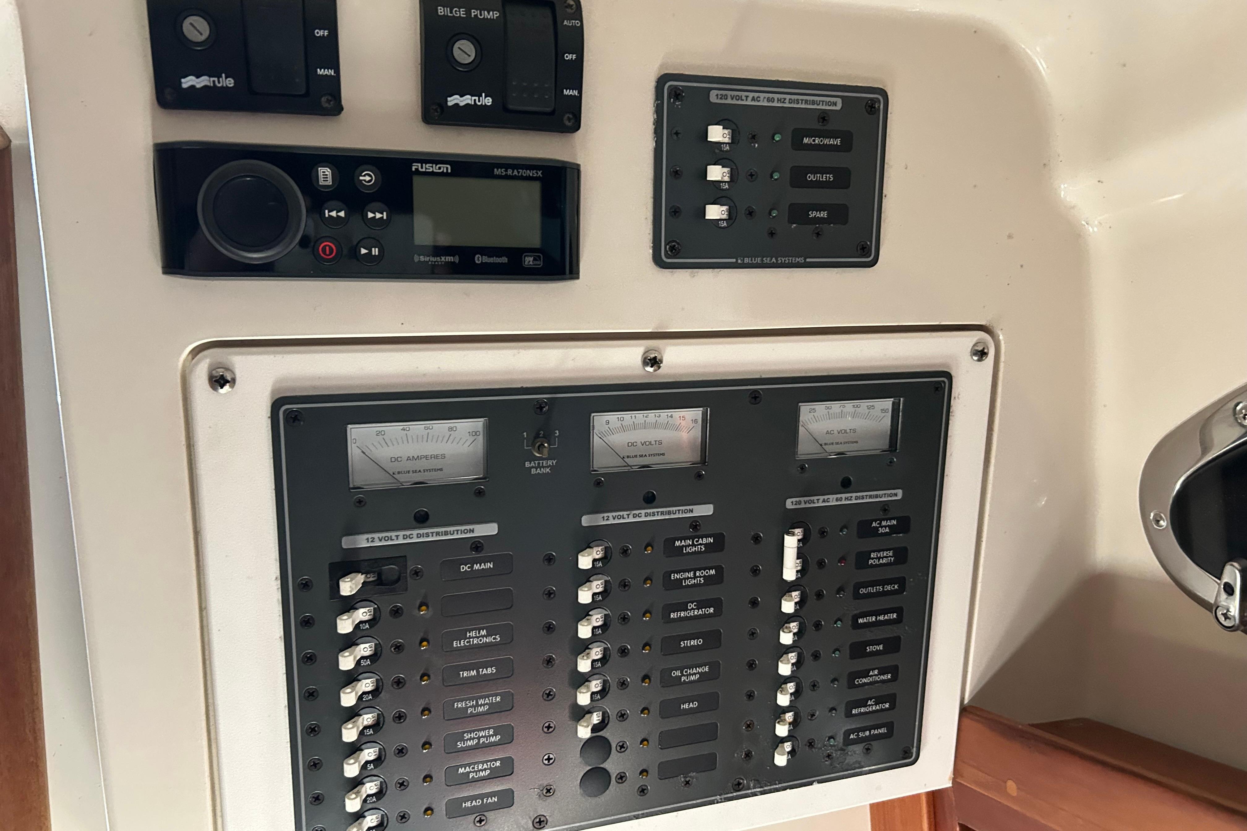 Control panel of a 2006 Back Cove 26 boat with switches and gauges.