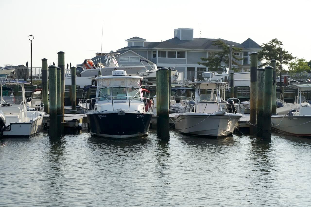 2006 Back Cove 26 boat docked among other vessels in a marina setting.
