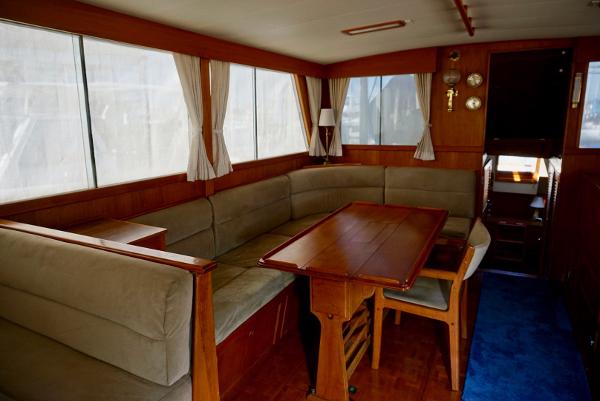 1982 Grand Banks Classic yacht interior with wood paneling and cozy seating area.