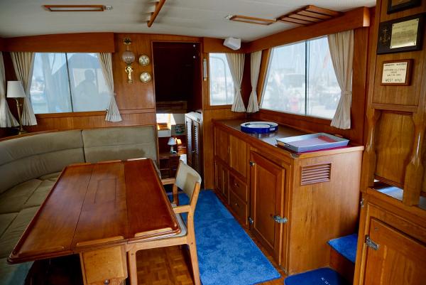 Interior of a 1982 Grand Banks Classic yacht with wooden furnishings and nautical decor.
