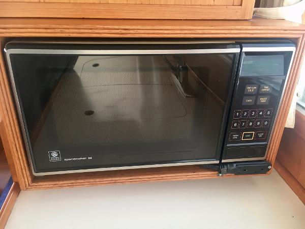 1982 Grand Banks Classic microwave in wooden kitchen setting.