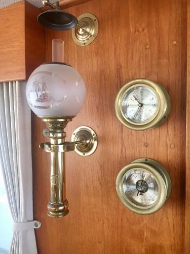 Vintage brass lamp and gauges on 1982 Grand Banks Classic yacht interior.