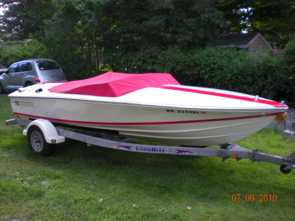 2008 Donzi 18 Classic boat with red cover on trailer.