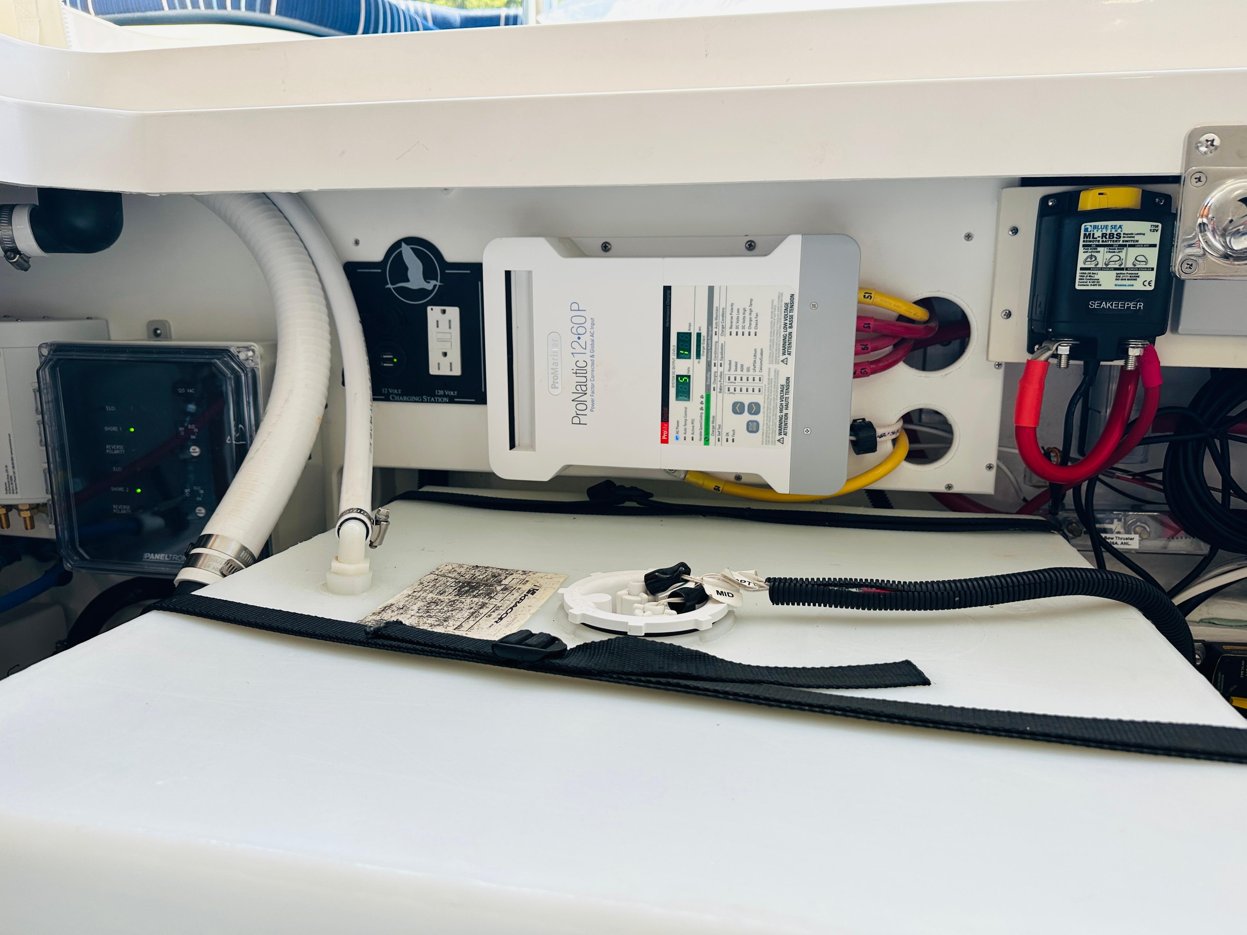 Electrical system inside a 2023 Back Cove 34O boat, featuring wiring and control panels.