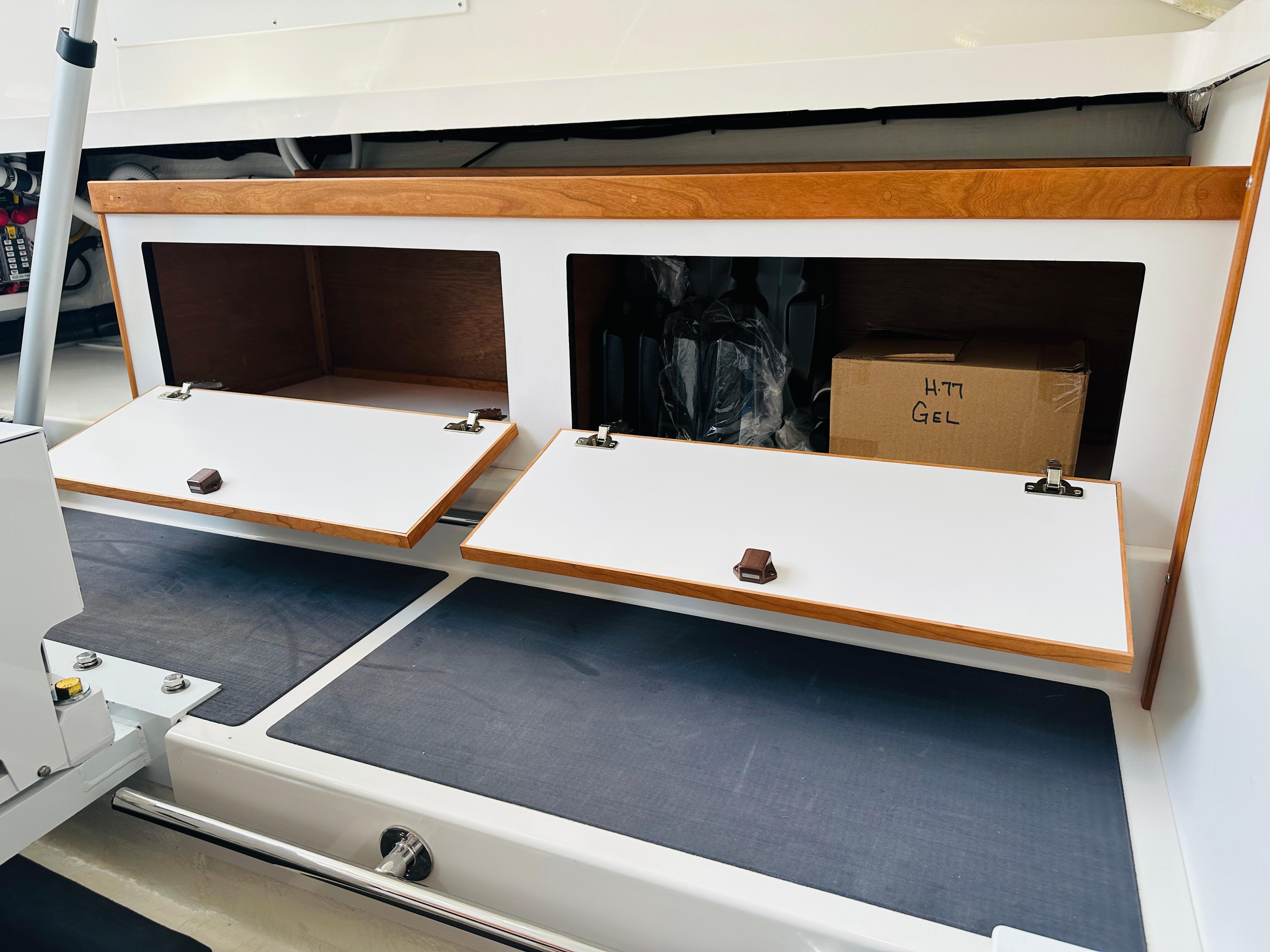 2023 Back Cove 34O boat storage compartments with open wooden doors.