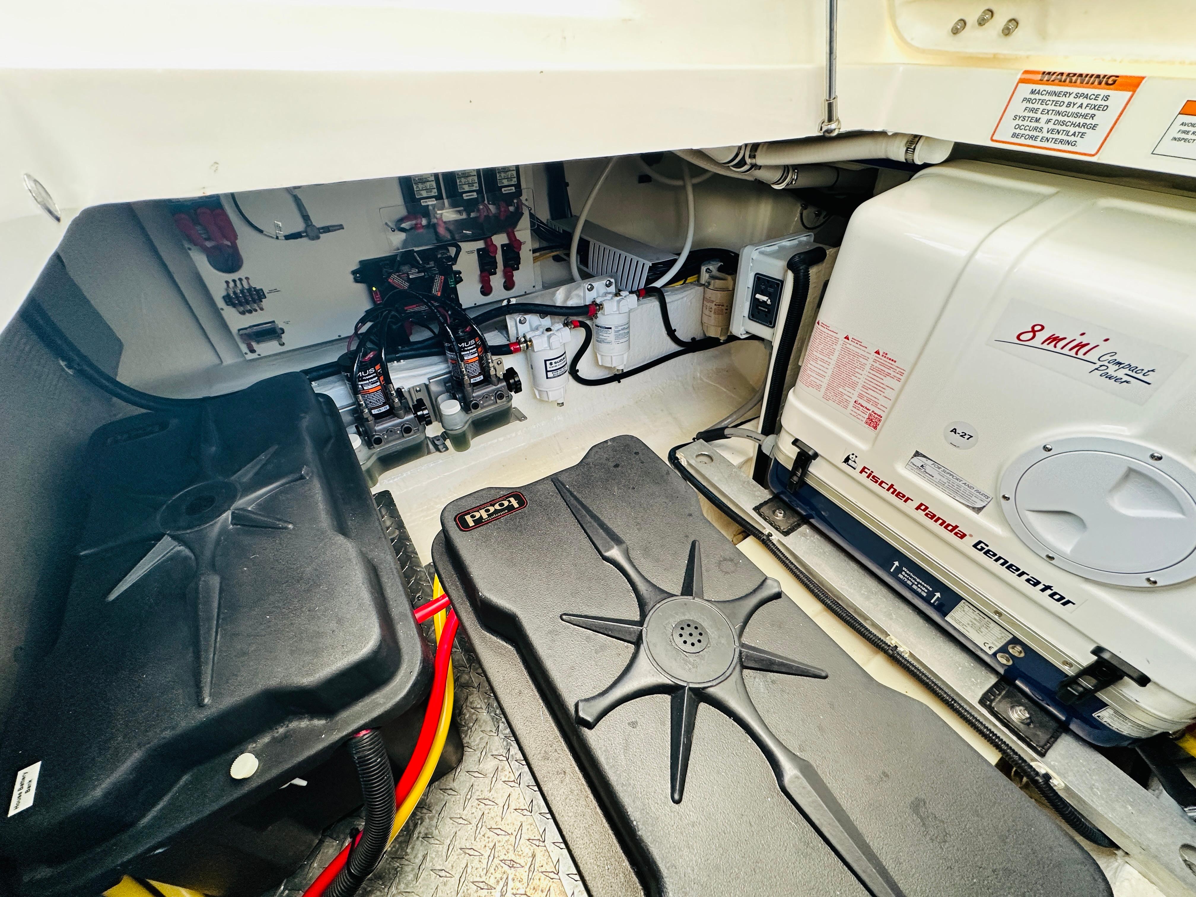 Engine room of 2023 Back Cove 34O with Fischer Panda generator and electrical components.