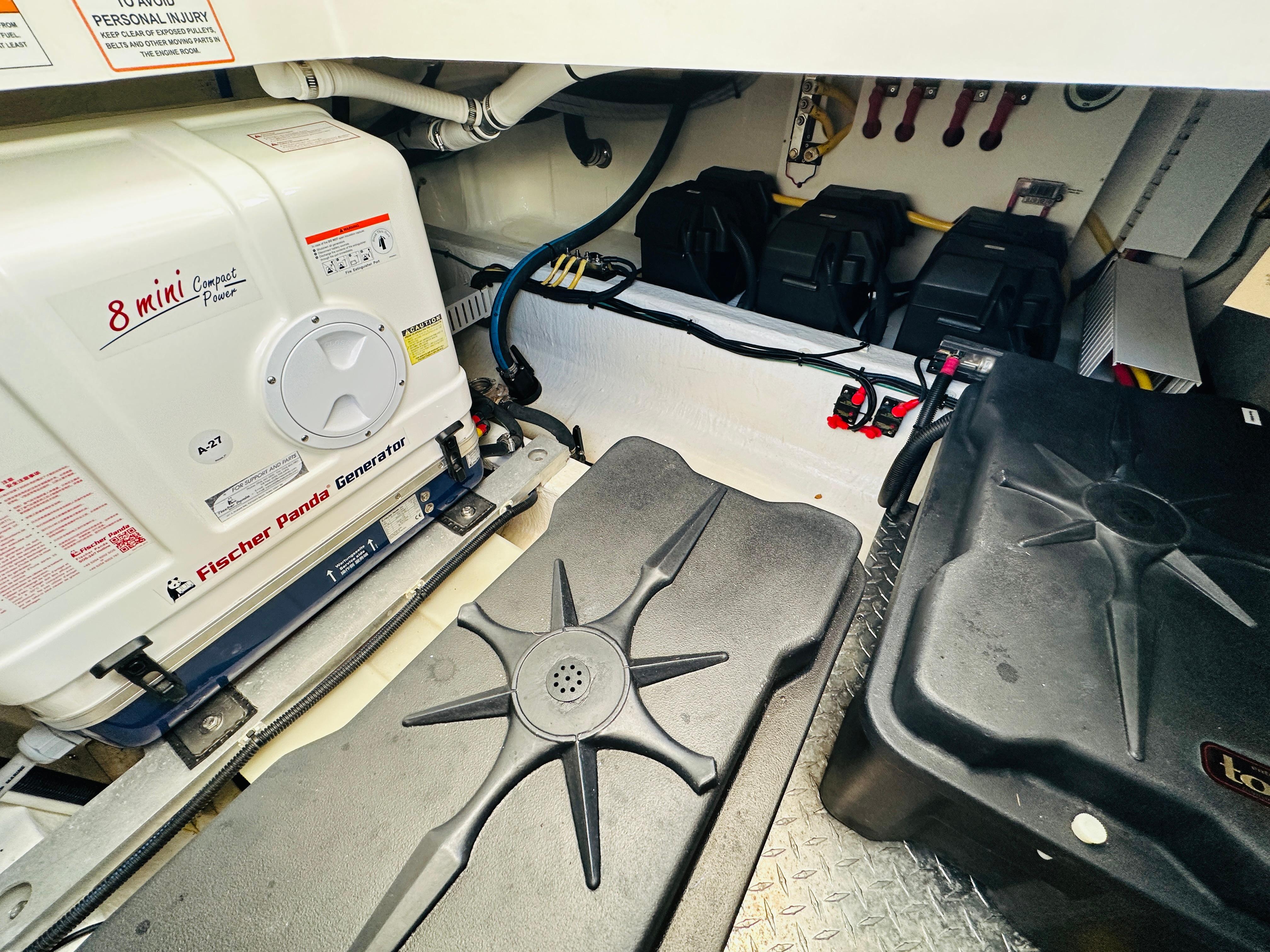 Engine room of 2023 Back Cove 34O with Fischer Panda generator and battery setup.