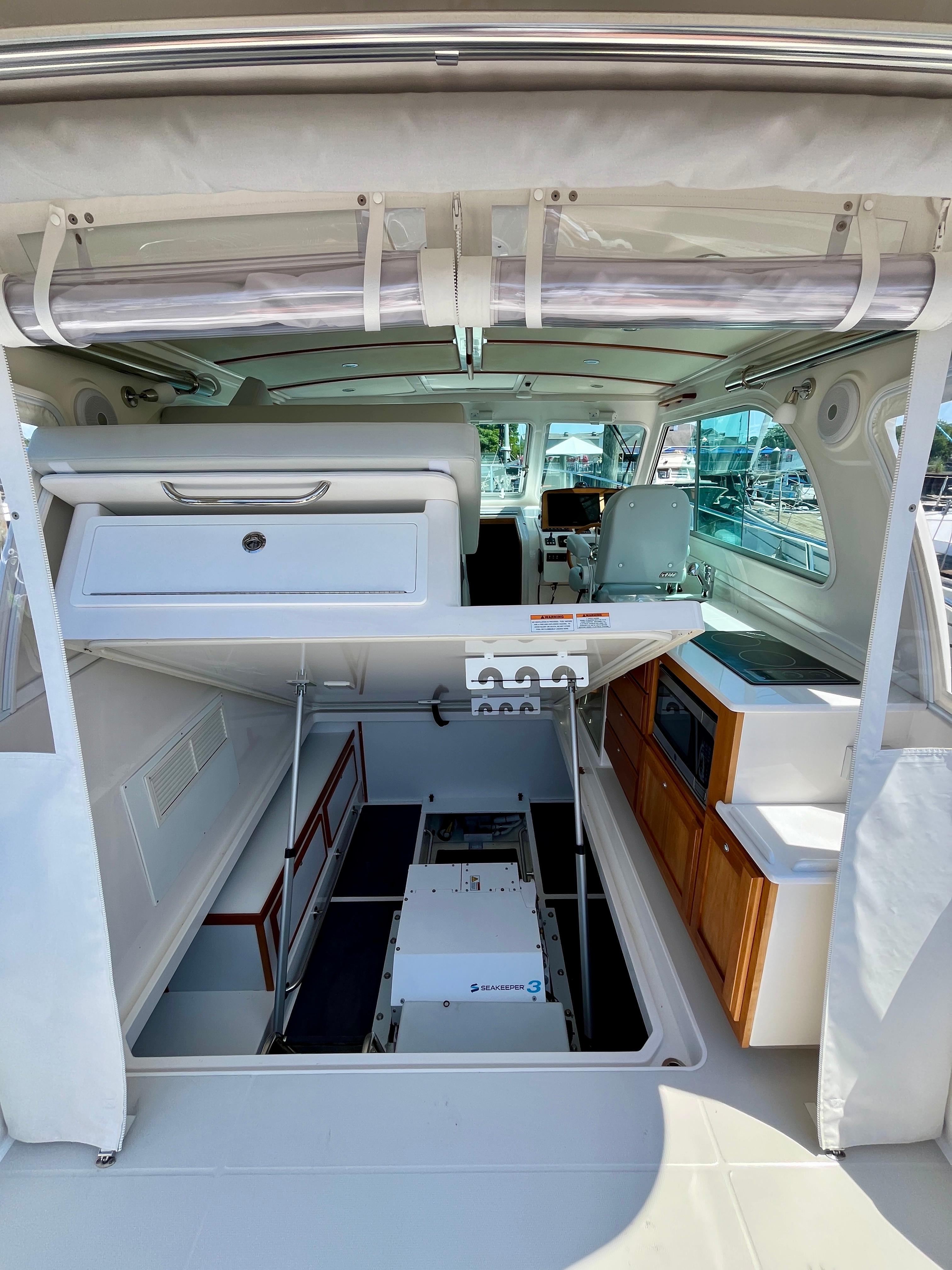 2023 Back Cove 34O yacht interior with open engine compartment and modern amenities.