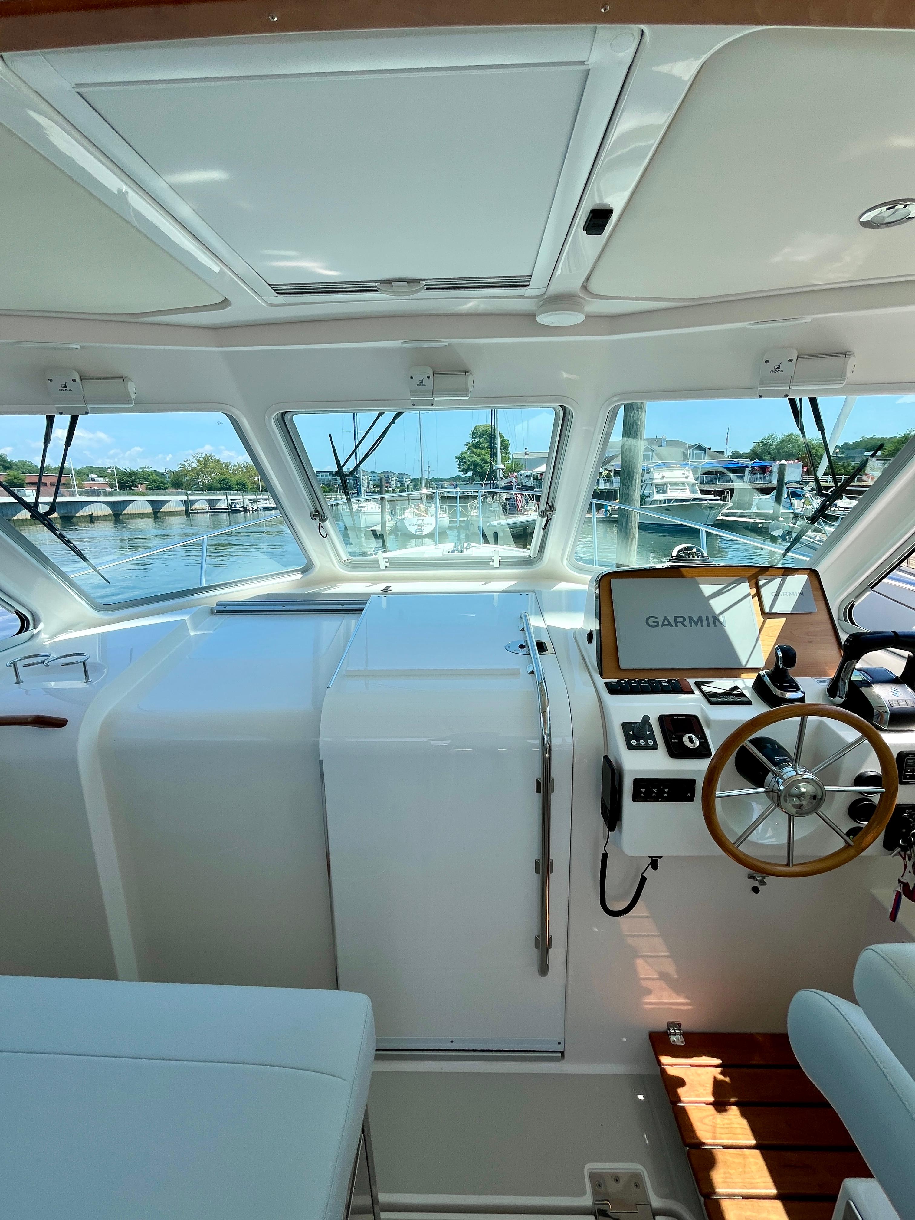 Interior view of 2023 Back Cove 34O boat cockpit with Garmin navigation system.