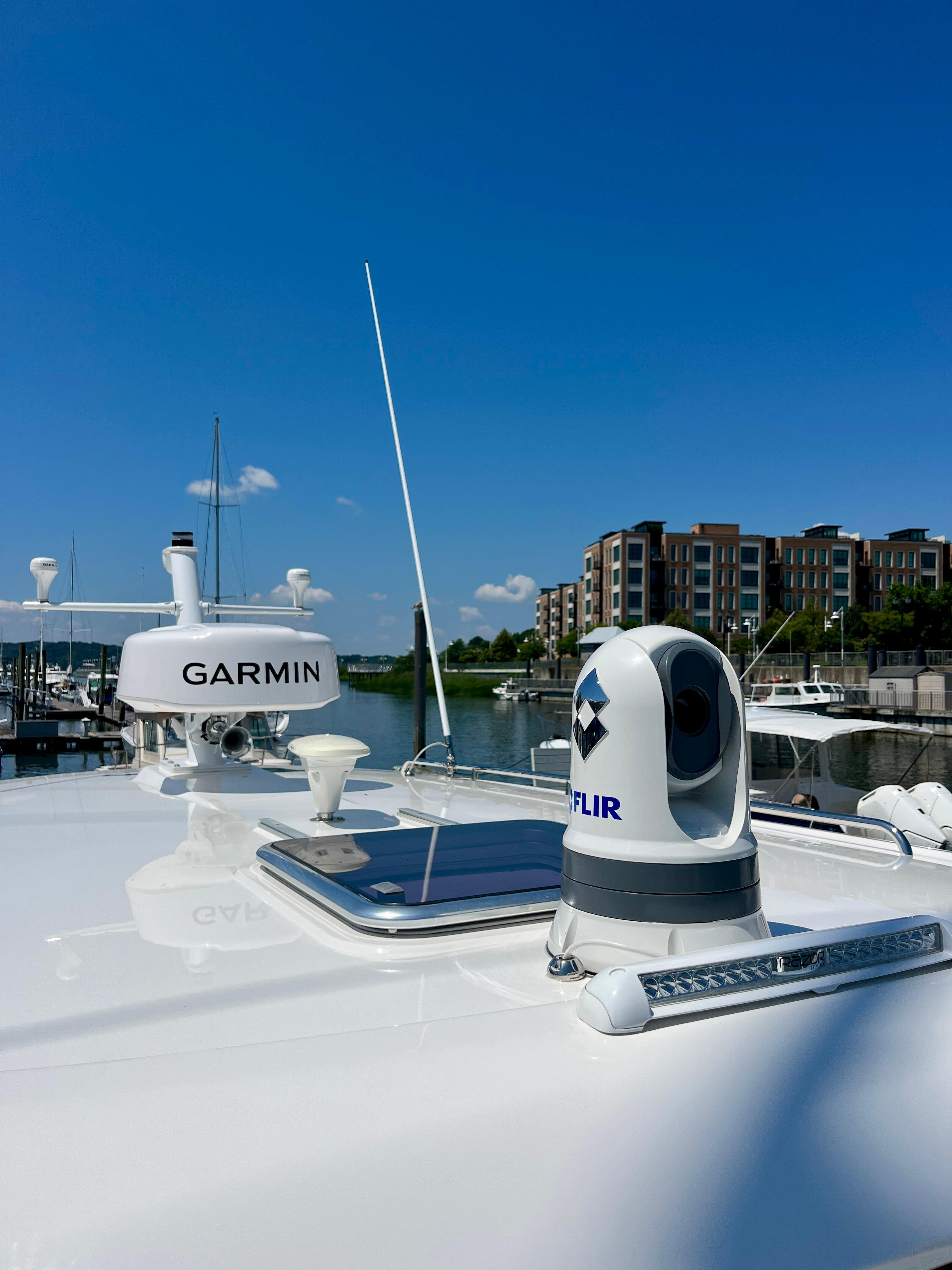2023 Back Cove 34O yacht with Garmin and FLIR equipment, docked near modern buildings.