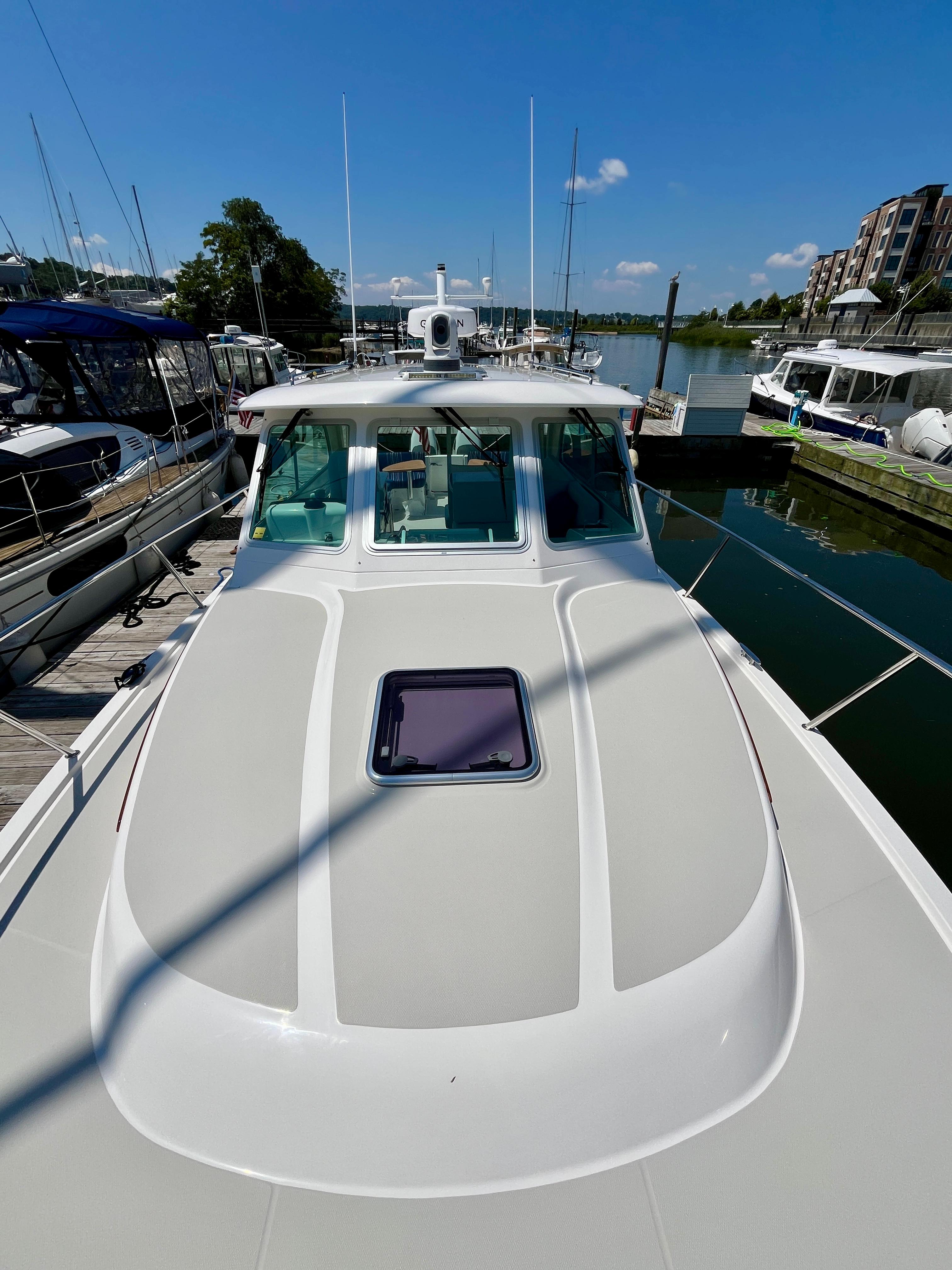 2023 Back Cove 34O boat docked at marina under clear blue sky.